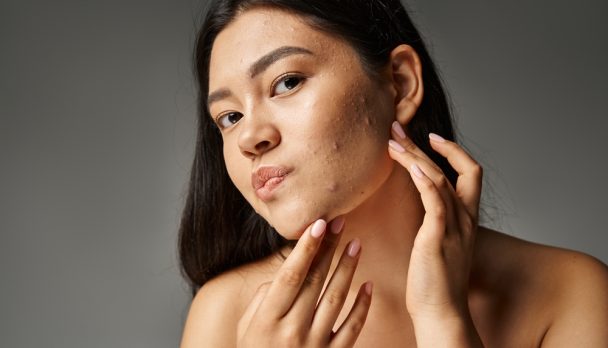 Young,Asian,Woman,With,Brunette,Hair,And,Naked,Shoulders,Touching